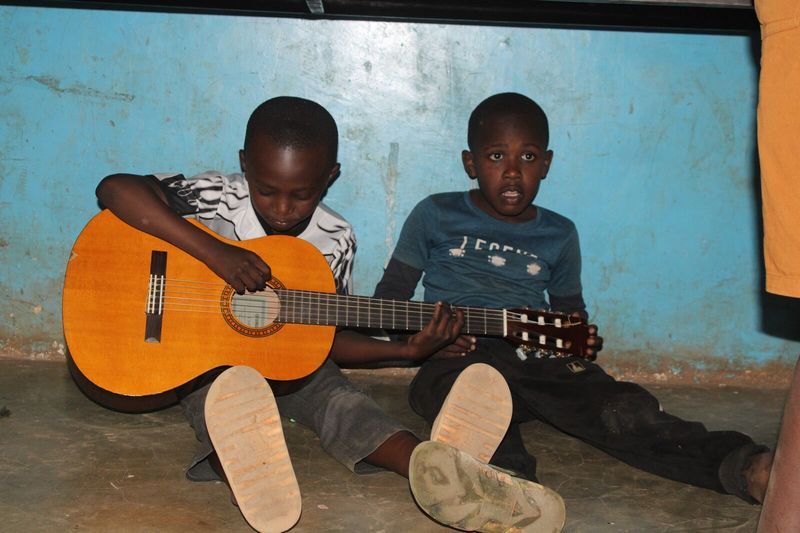 Group playing guitar together — Talent